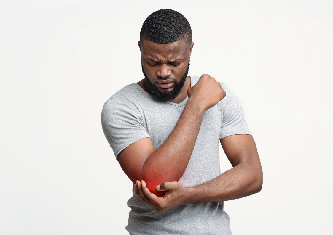 A black man in a white t-shirt looks down and holds his elbow, which is animated in glowing red to show pain, illustrating the blog post Acupuncture for Pain: Managing Winter Joint Pain the TCM Way